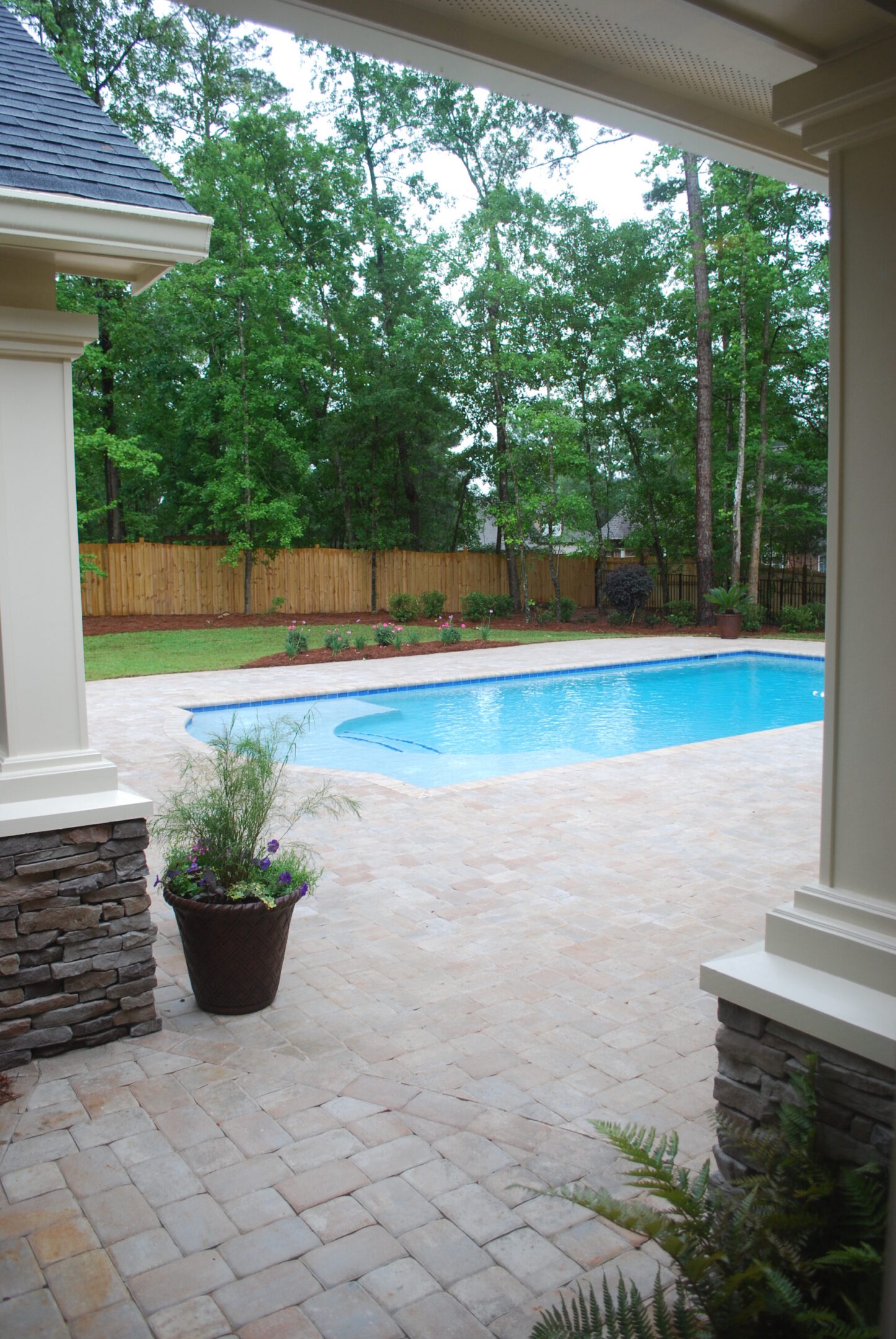 Backyard pool with stone patio